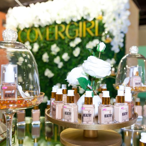 An elegant display of CoverGirl Vitalist Healthy Elixir Foundation and the floral photo wall